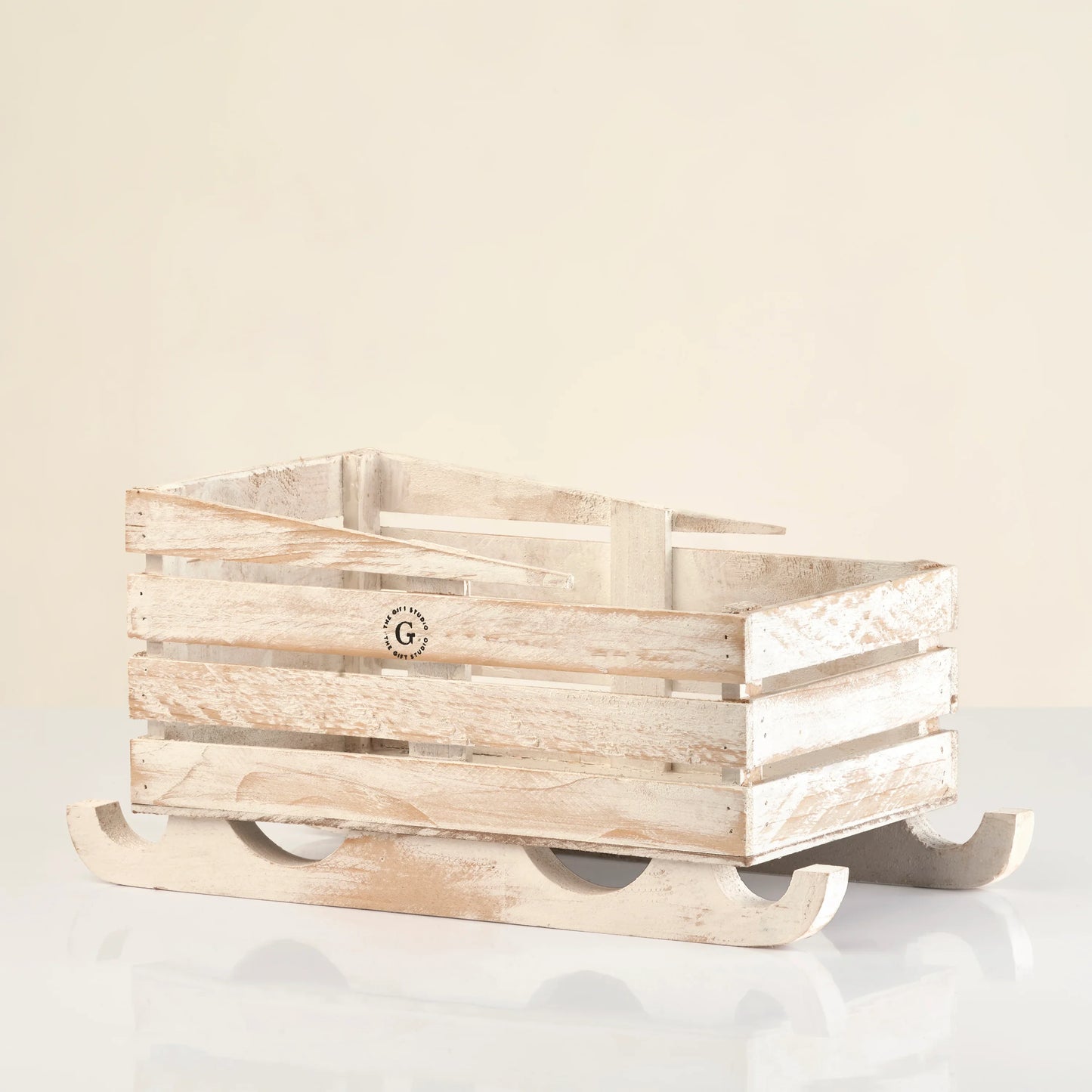 Rustic wooden crate shaped like a sled, ideal for holiday gift hampers and decor.
