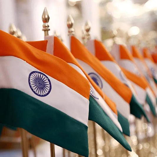 Row of Indian flags with saffron, white, and green stripes and blue Ashoka Chakra on flagpoles