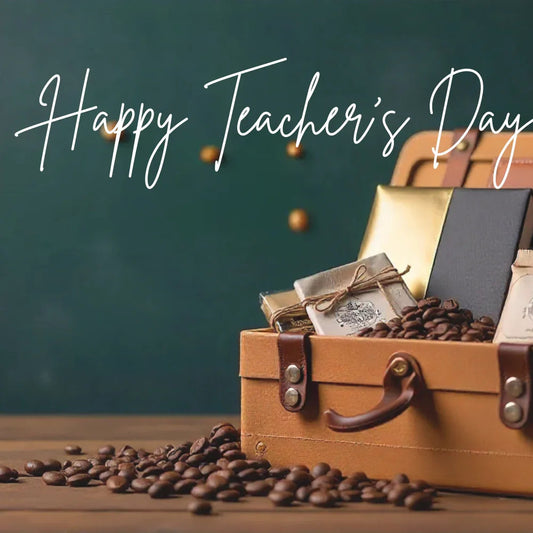 Happy Teacher's Day gift hamper with coffee beans, notebooks, and wrapped gifts in a leather box