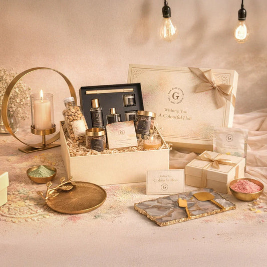 Luxury Holi gift hamper with candles, snacks, skincare products, festive decor, and gift box.