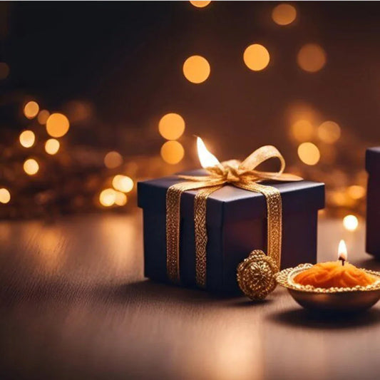 Gift box with golden ribbon and festive candle, perfect for unique gift hampers