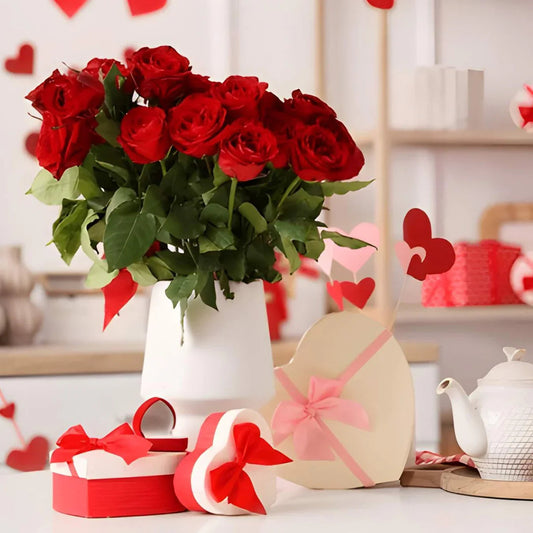 Bouquet of red roses in vase with heart-shaped gift boxes and red ribbon, romantic gift setup