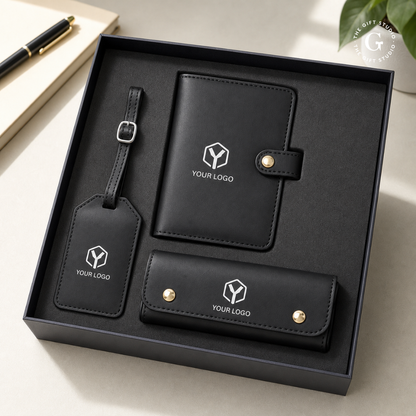 Black leather luggage tag, passport holder and a eyewear case with TGS branding and a luxury gifting box.
