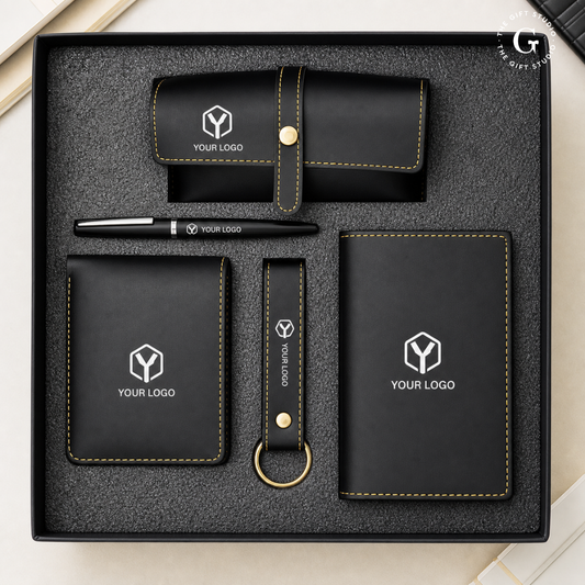 Black branded stationery set with metal pen, eyewear case, wallet, keychain and passport cover with TGS branding.