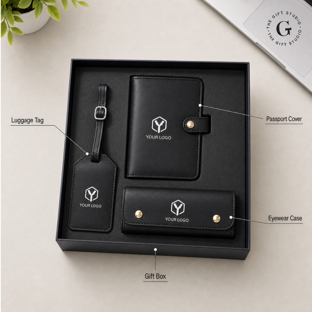 Black leather luggage tag, passport holder and a eyewear case with TGS branding and a luxury gifting box.