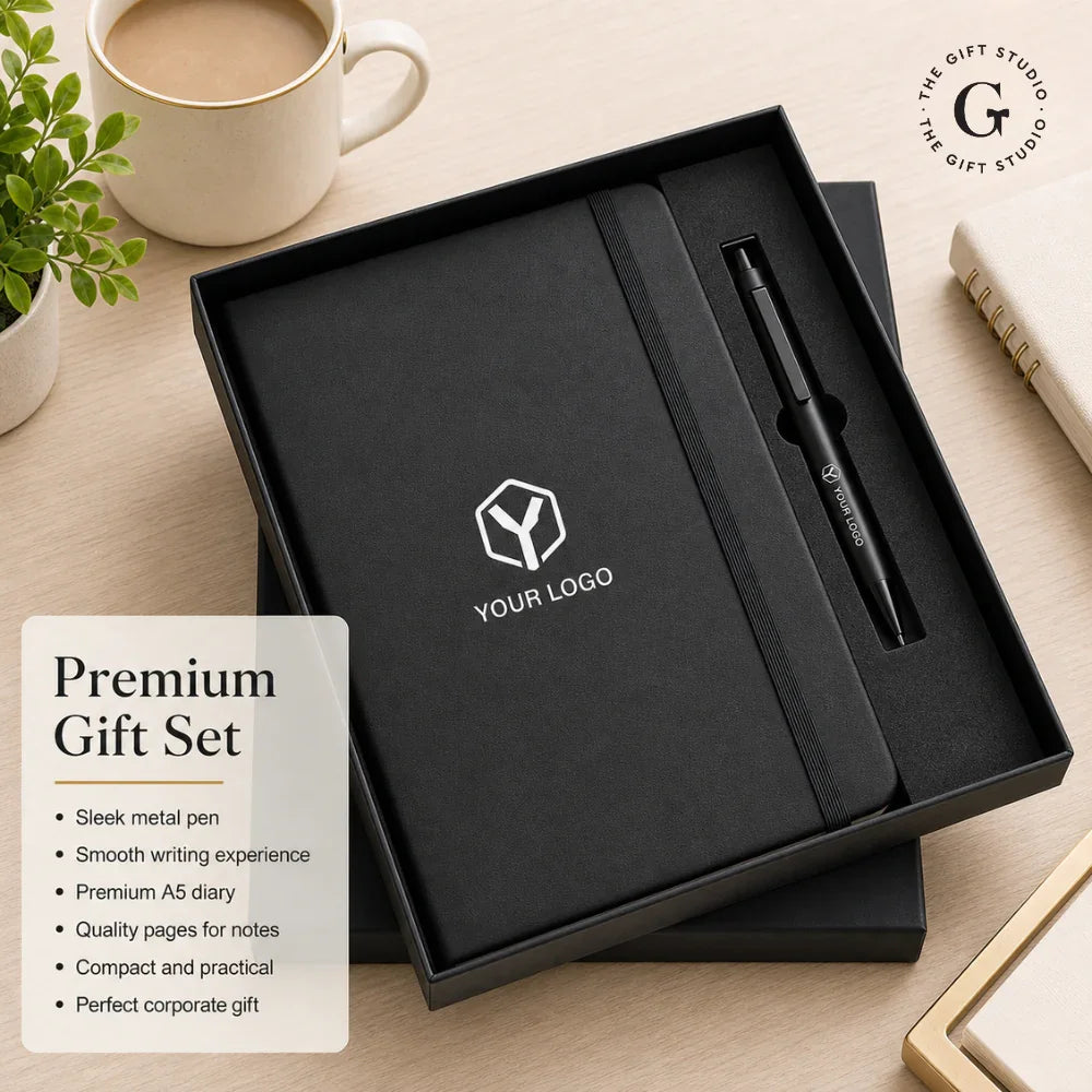 TGS Black notebook with pen and logo in a box on a desk 