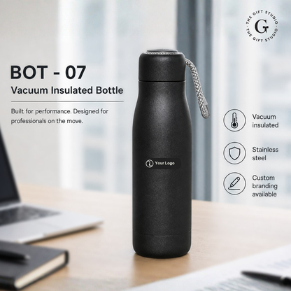 Black vacuum insulated bottle on a desk with branded 'The Gift Studio'.