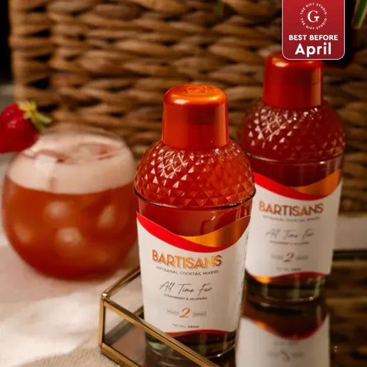 Bartisans cocktail mixers with glass of strawberry drink on table, premium gift option