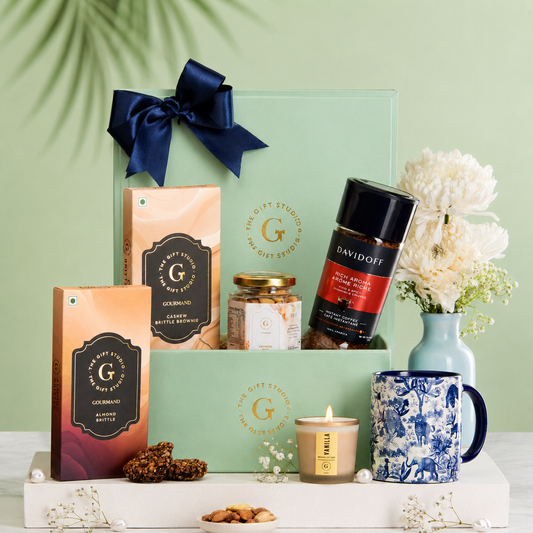 Coffee & Crunch hamper products artfully displayed outside the mint gift box.