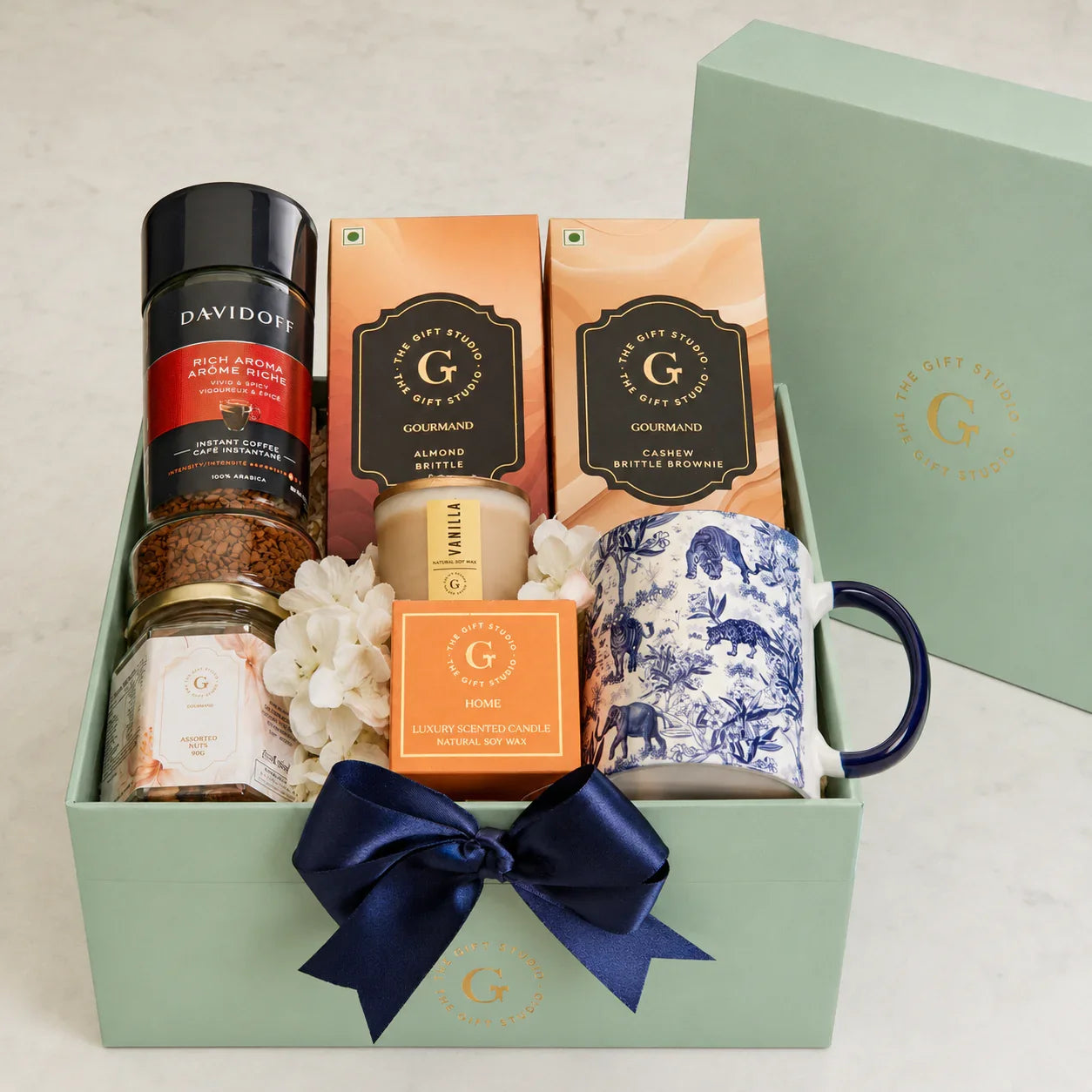 All Coffee & Crunch hamper items neatly organized inside the open mint gift box."