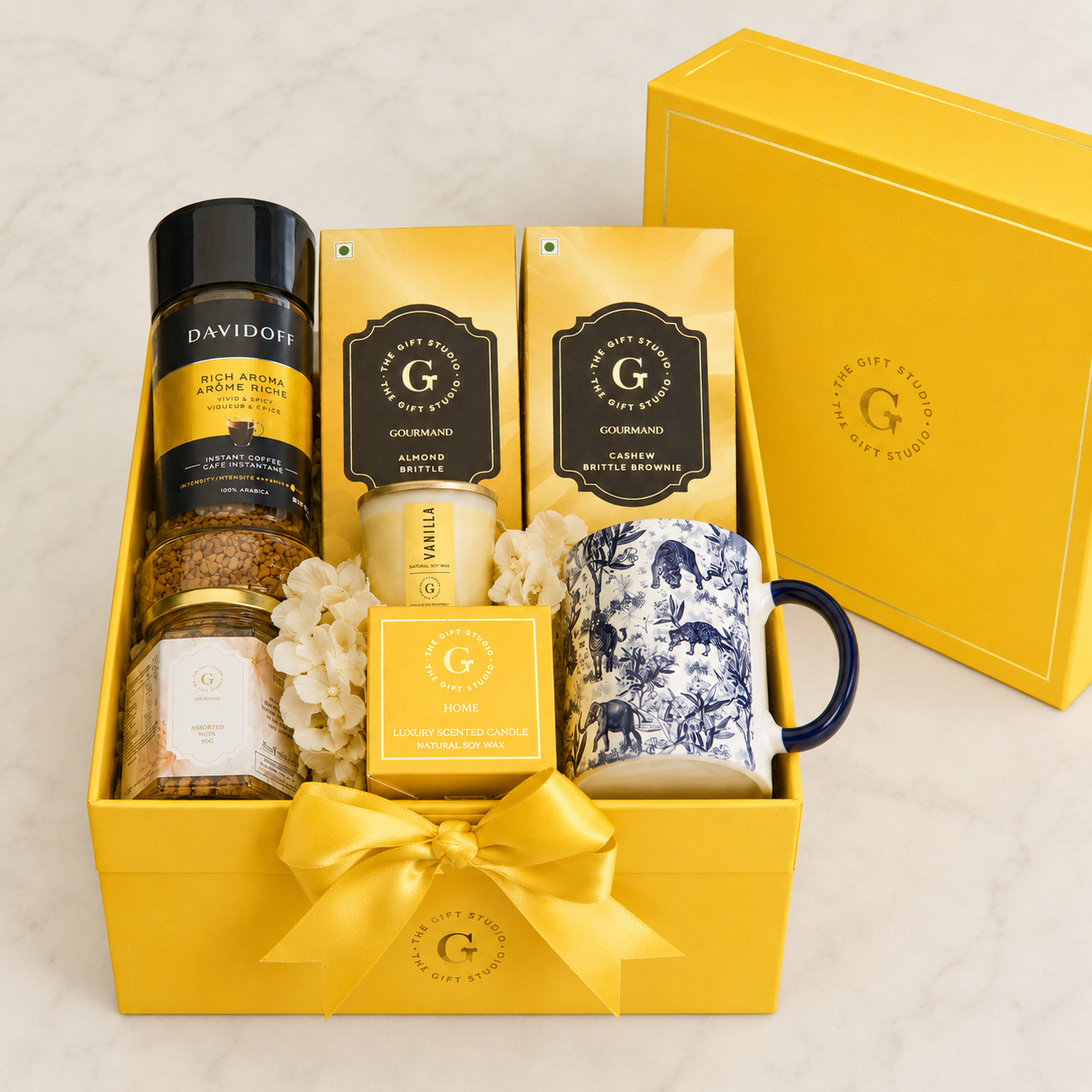 All Coffee & Crunch hamper items neatly organized inside the open yellow gift box.