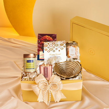 Delightful Diwali Hamper by The Gift Studio featuring sweets, a candle, and a golden bowl.