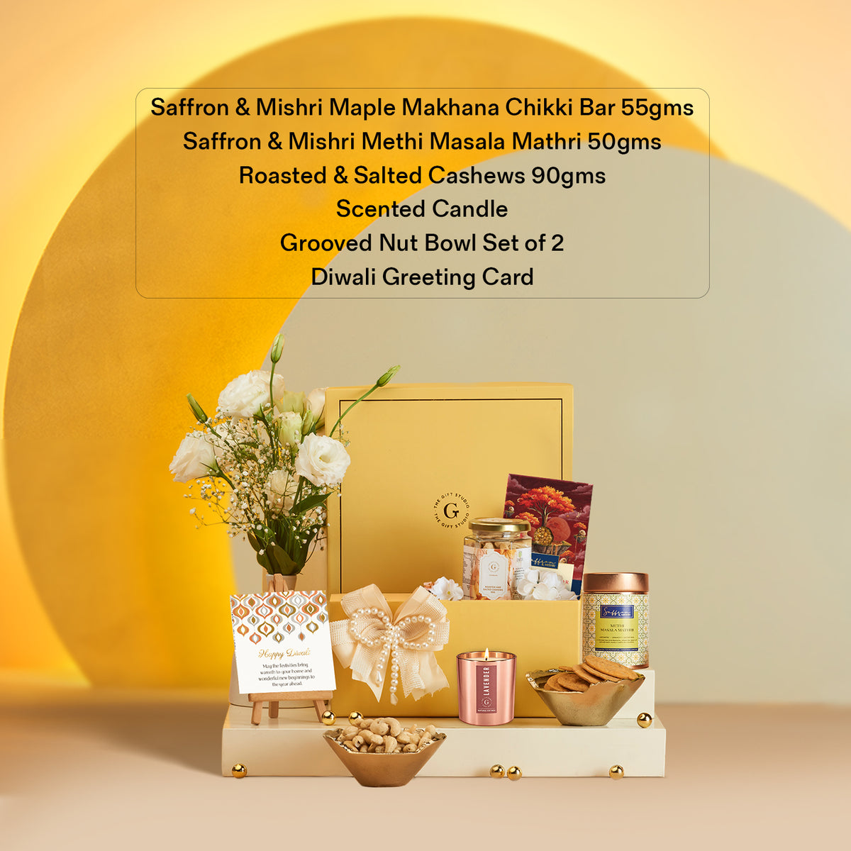 Delightful Diwali Hamper by The Gift Studio with sweets, nuts, candle, and flowers.