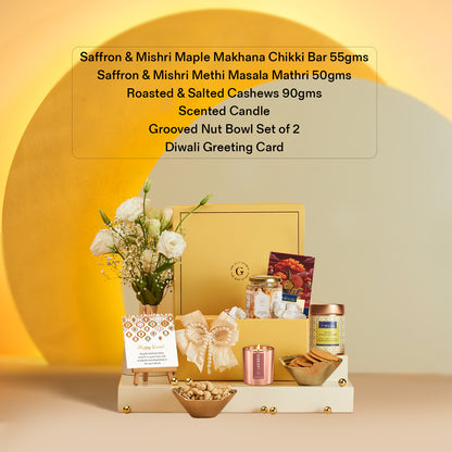 Delightful Diwali Hamper by The Gift Studio with sweets, nuts, candle, and flowers.