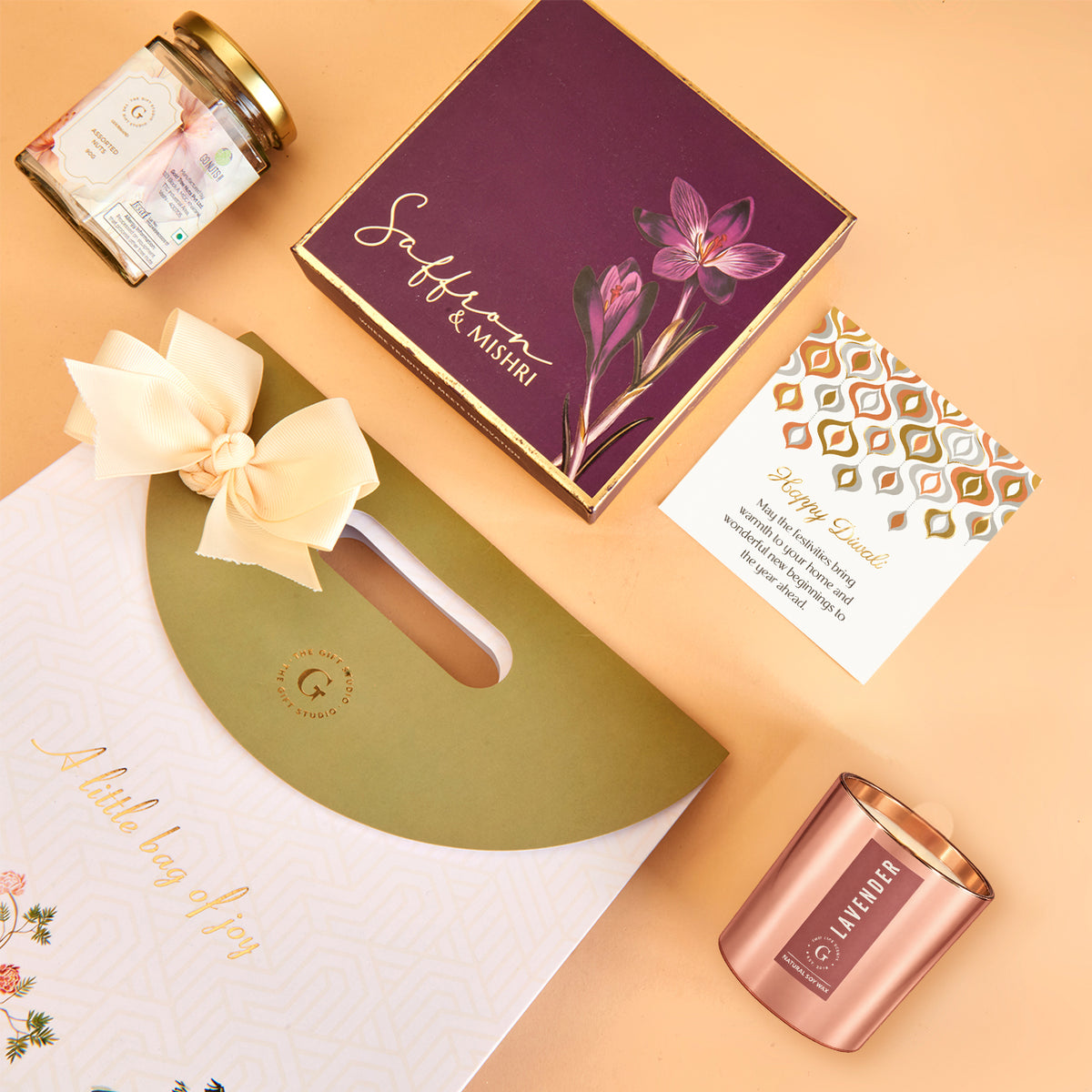 The Gift Studio Diwali Radiance Gift Bag with saffron sweets, lavender candle, and a greeting card.