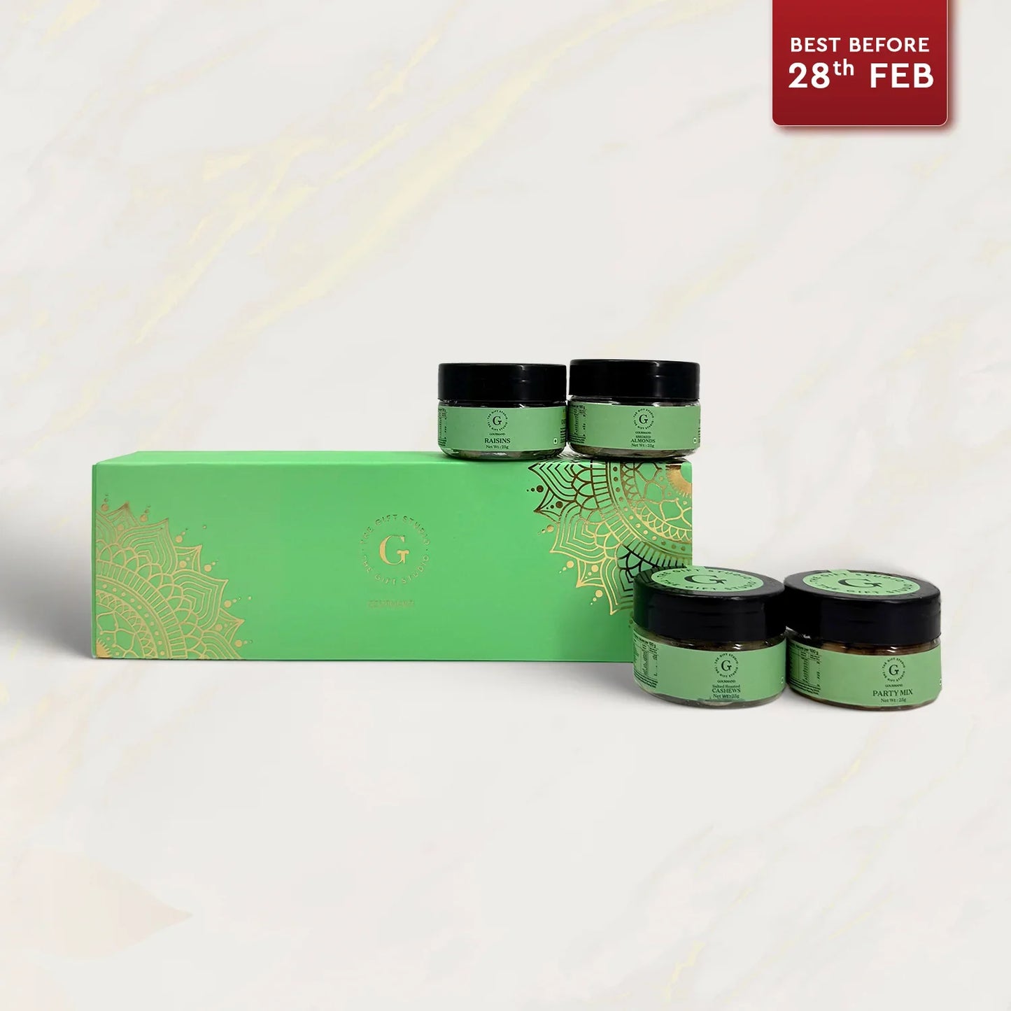 Nutty treat gift box with four green jars of mixed nuts, perfect for gifting occasions.