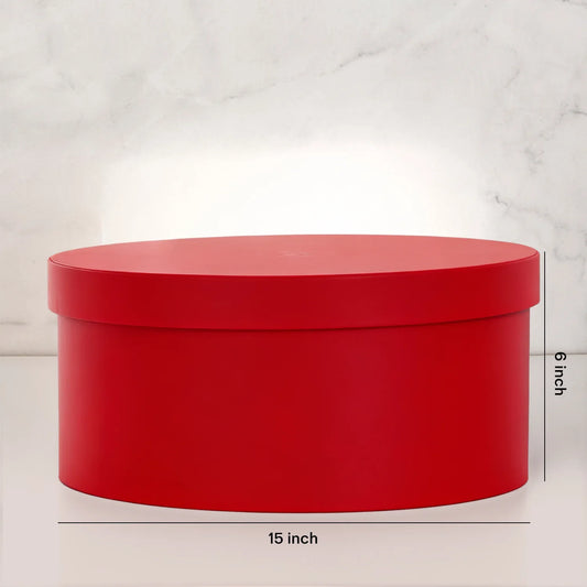 Large red round gift box with lid, 15 inch wide and 6 inch tall, on a marble surface.