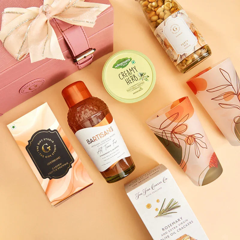 A top-down flat lay showing the full The Happy Hour Hamper assortment.